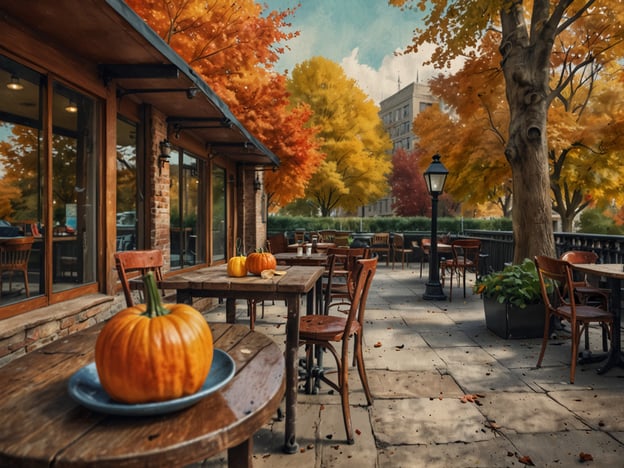 Auf dem Bild ist eine herbstliche Außenterrasse eines Cafés oder Restaurants zu sehen, dekoriert mit Kürbissen und umgeben von bunten, herbstlichen Bäumen. Hier sind einige praktische Tipps für deine Städtereise im Herbst:

1. **Kleidung**: Trage Schichten! Das Wetter kann wechselhaft sein, mit warmen Tagen und kühlen Abenden.

2. **Aktivitäten im Freien**: Nutze die bunten Herbstfarben für Spaziergänge in Parks oder botanischen Gärten. Das ist eine großartige Möglichkeit, die Natur zu genießen.

3. **Kürbisfeste**: Informiere dich über lokale Kürbisfeste oder Ernteveranstaltungen, die oft im Herbst stattfinden.

4. **Cafés und Restaurants**: Probiere gemütliche Cafés aus, die Herbst-Spezialitäten anbieten, wie Kürbiskuchen oder heiße Schokolade.

5. **Fotomöglichkeiten**: Halte deine Kamera bereit für wunderschöne Herbstlandschaften und farbenfrohe Blätter. 

6. **Frühzeitig planen**: Viele Städte sind im Herbst beliebt für Kurzurlauber, also plane deine Unterkünfte und Aktivitäten im Voraus.

Viel Spaß bei deiner Städtereise!