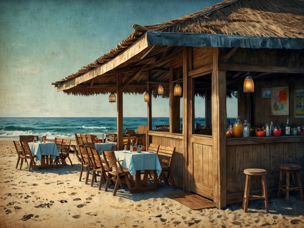 Auf dem Bild ist ein Strandrestaurant zu sehen, das aus Holz gebaut ist und einen Überdachung hat. Vor dem Restaurant stehen mehrere Tische mit blauen Tischdecken und Stühlen, die auf dem Sand stehen. Im Hintergrund sieht man das Meer und den Strand. An der Theke sind verschiedene Getränke in Flaschen und Gläsern ausgestellt, die auf eine einladende Atmosphäre hinweisen. Es scheint ein idealer Ort zu sein, um am Strand zu speisen und zu entspannen.