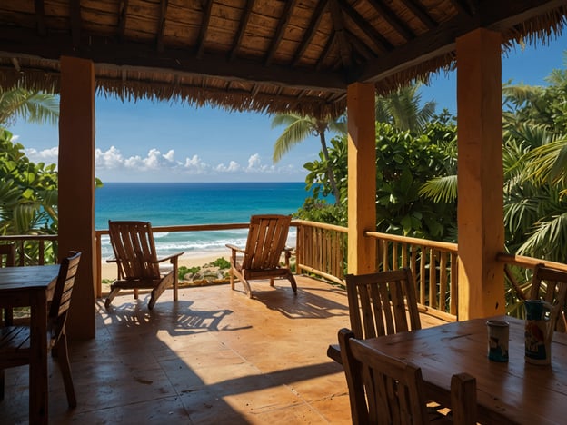 Auf dem Bild ist eine gemütliche Terrasse zu sehen, die einen herrlichen Blick auf den Ozean bietet. Die Unterkunft scheint ein idealer Ort zum Entspannen zu sein, mit Holzmöbeln, die zum Sitzen einladen. Die Umgebung ist tropisch und grün, was eine entspannende Atmosphäre schafft. Die Terrasse könnte Teil eines Restaurants oder einer Unterkunft sein, wo Gäste viele schöne Stunden mit Blick auf das Wasser verbringen können.