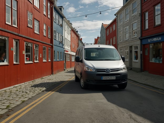 Auf dem Bild ist ein Fahrzeug in einer engen Stadtstraße zu sehen, die von bunten Gebäuden gesäumt ist. Die Fassaden der Häuser sind überwiegend rot, blau und grau. Diese Szene könnte in einem malerischen Stadtteil einer skandinavischen Stadt aufgenommen worden sein.

**Anreise:**
Um zu diesem Ort zu gelangen, kannst du einen Flug zu dem nächstgelegenen großen Flughafen nehmen und von dort entweder ein Auto mieten oder öffentliche Verkehrsmittel nutzen. Viele Städte bieten auch direkte Zugverbindungen.

**Praktische Tipps für deinen Besuch:**
1. **Beste Zeit für einen Besuch**: Der Frühling oder Sommer sind ideal, um das milde Wetter und die lebendigen Farben der Stadt zu genießen.
2. **Parkmöglichkeiten**: Informiere dich im Voraus über Parkplätze, da enge Straßen häufig begrenzte Parkmöglichkeiten haben.
3. **Öffentliche Verkehrsmittel**: Nutze Busse oder Straßenbahnen, um die Stadt bequem zu erkunden, insbesondere wenn die Straßen eng sind.
4. **Essen und Trinken**: Probiere lokale Spezialitäten in den umliegenden Cafés und Restaurants; viele bieten frische, regionale Zutaten.
5. **Fotomöglichkeiten**: Halte die Kamera bereit, um die bunten Häuser und die charmante Atmosphäre festzuhalten, besonders bei Sonnenuntergang.